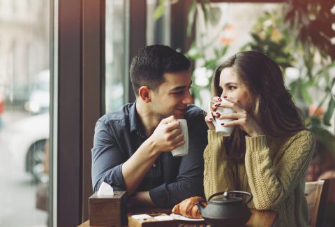 Couple in love drinking coffee in coffee shop